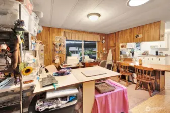 Generous sized family room has TONS of storage space. Updated lighting. Currently it's the sewing and craft room