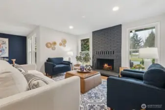 The beautifully accented fireplace—with windows on each side—creates a balanced, eye-catching focal point that transforms the entire room. Sunlight filters in throughout the day, bringing an airy brightness that complements the home’s modern updates.