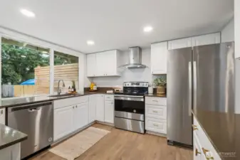 The large windows provide lots of natural light and open views to the large, fully fenced back yard.