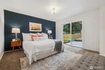 Retreat to a spacious Primary bedroom with walk in closet and EnSuite offering comfort, privacy, and room to unwind. This King Sized bed easily fits in this large Suite and enjoys a slider out to the back yard. Hot tub, anyone?