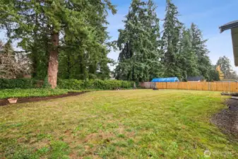 The level, fully fenced back yard is thoughtfully landscaped for maximum privacy.