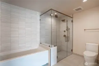 Oversized shower with massage fixtures and beautiful tile work.