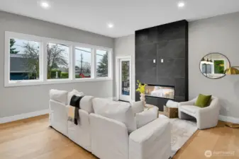 Living room with views, electric fireplace and door to the BBQ deck