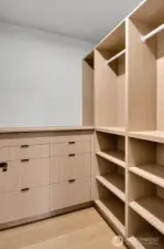 Primary walk in closet with built-in organizers