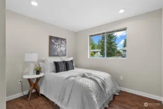 Each of 2 guest bedrooms include laminate flooring, a nice sized window and ceiling can lights to brighten the room.