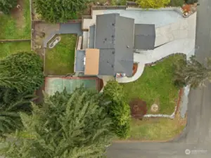 The aerial photograph highlights the extensive parking this home offers as well as the large back yard setting.