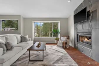 A fireplace in the living room will keep you cozy on rainy days.  The surrounding custom tile work from floor to ceiling create a beautiful focal point to the room.