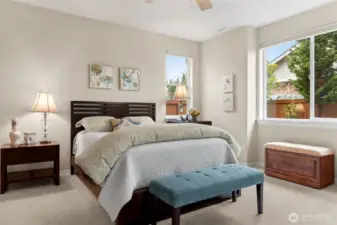 Generous primary suite looks out to back yard