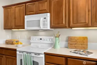 Kitchen has lots of cabinet for storage.