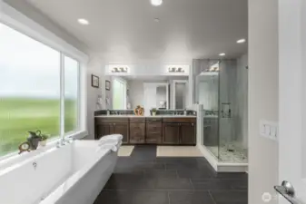 Luxurious Primary Bath with dual vanity, soaking tub, large shower and spacious walk-in-closet