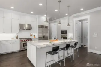 Chef's Kitchen with top of the line appliances, central kitchen and large walk-in-pantry