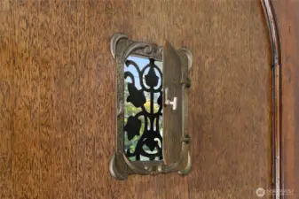A vintage "peep-hole" inset in the front door.