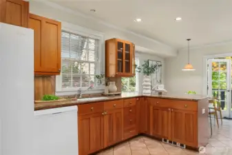 Behind a "swing-door" you enter the kitchen.  Lots of smart storage, stone counters & room for a breakfast table.