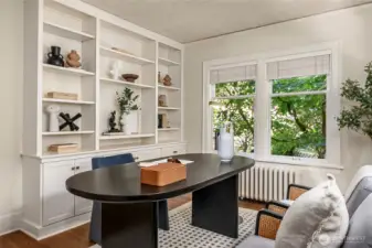 This is either a main floor den/office or a 4th bedroom (or both if you add a Murphy bed or sleeper sofa).  If using as your office there is plenty of built-in storage and bookcase space plus a closet.  Love the greenery outside the windows!