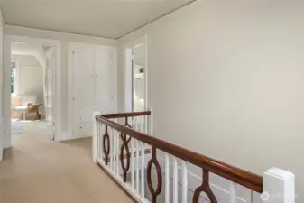 Upper hallway.  Linen closet straight ahead.  Primary bedroom is behind the open doorway on the right.