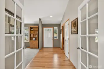 Entry way leads into the house with beautiful hardwood floors. Vaulted ceilings when you walk in.