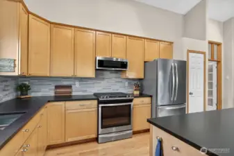 A close up of the kitchen counters & tile backsplash.