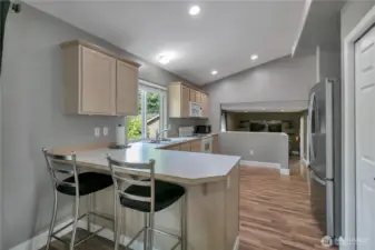 The kitchen is fully equipped with a refrigerator, range, dishwasher, smaller countertop microwave and breakfast bar--the stools stay!