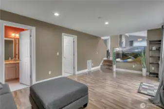There is a half bathroom (powder room) to the left and the second door leads to the utility room with a washer, dryer and storage area. From there you can access the large 2-car garage.