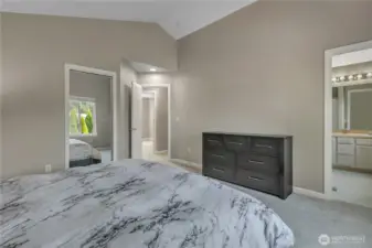 Another view of the large, primary suite. The access to the private bathroom is just to the right. The walk-in closet is just behind the mirrored doors to the left.
