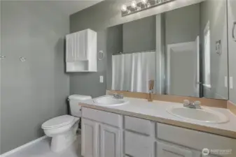 The primary bathroom has double sinks and a relaxing bathtub too.