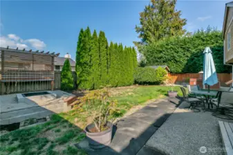 Here's a picture of the private backyard. There is a raised garden area to the far right, next to the large shed and to the left is the newer firepit! A large cement patio is a great place for friends and family to enjoy.