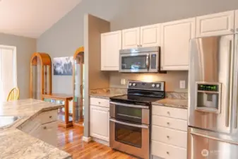 Updated kitchen with stainless steel appliances including a double oven.