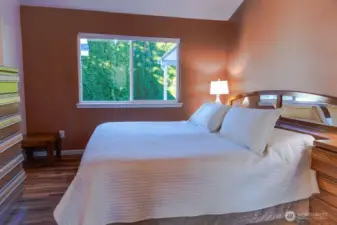 Primary suite also features vaulted ceilings.