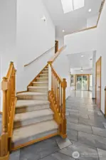 Tall ceilings, stairs leading to the second floor and new tile greet you as you step inside.