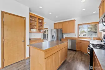 Make your way into the light-filled kitchen with an oversized pantry with shelving and newer refridgerator.