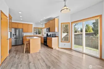 The eating area with sliding glass doors leads out to the back patio and fully fenced backyard.
