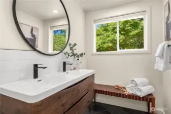 The private bath off the primary offers dual sinks, nice storage, extensive tile work and a walk-in shower.