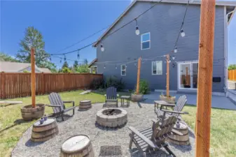 North backyard set up with seating, firepit & party lights