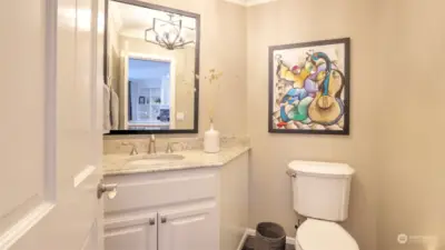 Main level powder room off kitchen.