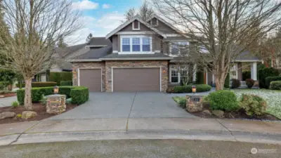 Circular driveway provides convenient access for both arrivals and departures. 3 car finished garage with storage, EV charging, & silent garage door openers.