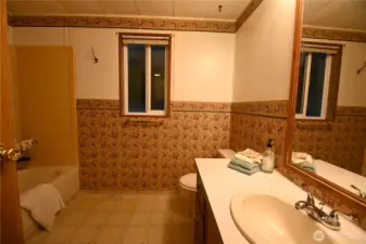 Full bath offers a functional design and floor to ceiling storage (behind the door) ~ everything you need for easy living.