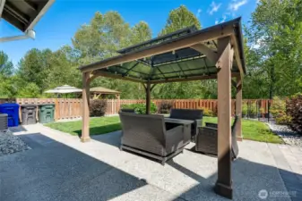 Paver walkway, extended patio with gazebo with lighting, dedicated flowering perennials, with greenbelt views. Room for gathering, for BBQing, for play, and pets. The gazebo is a daytime/night-time outdoor space you'll use and love all year long.