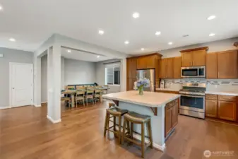 Open kitchen and dining space which allows room for an extended table and hutch.  Island seating on two sides. Many of the cabinets have custom pull out drawers on the lower and upper cabinets.