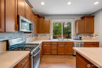 Gas range with griddle. Large kitchen window takes view of the landscaped yard and greenbelt.
