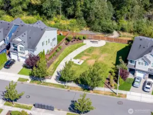 Another community shared space with trail visible past the fenceline.