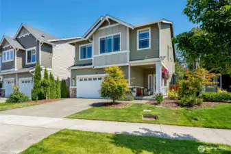 Driveway parking for guests, two car garage, covered front porch and the flower baskets are watered by a drip system.