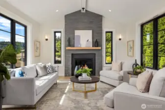 Livingroom featuring generous windows with stacked stone fireplace and custom mantel