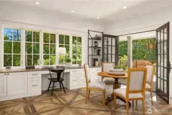 Charming breakfast area with french doors out to covered porch overlooking the waterfall and pond