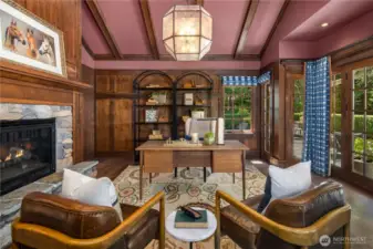 This room functions beautifully as an office or private dining room. Richly appointed with paneled walls and vaulted ceilings and a stone fireplace.