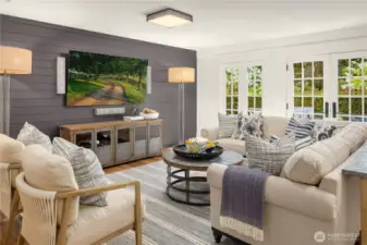 Garden level family room has a wall mounted television with surround sound