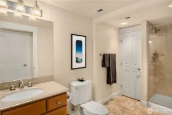 The guest bathroom is spacious and offers additional storage.