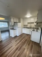 Unit 107 - Both units offer new vinyl plank flooring throughout kitchen and living room.