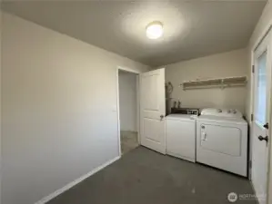 Laundry room located in the garage, offering lots of extra storage space