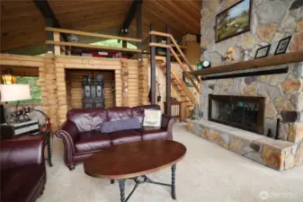 Airy upper level with skylights, panoramic windows, and a double-sided fireplace