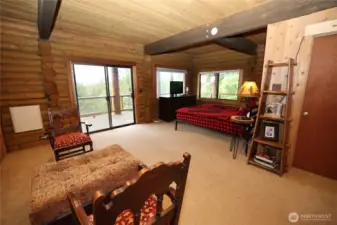 Primary bedroom featuring fireplace and seamless access to a newly built deck